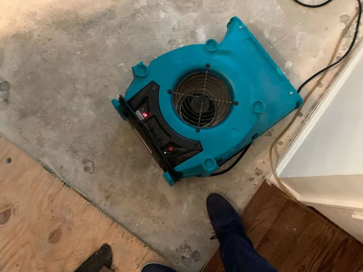 Air mover drying subfloor during Commercial Water Damage Restoration in Pampa